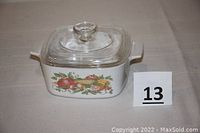 Front view of the white square casserole dish with Garden Harvest vegetable pattern and clear lid