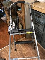 Full view of Cosco 2-step step stool with metal frame and black wide steps.