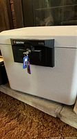 Front view of the SentrySafe fire safe showing the black locking panel with two keys inserted.