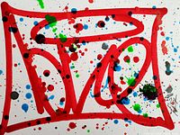 Close-up front view showing vivid red geometric lines and multi-colored paint splatter on white Bristol paper, signed by artist in black on lower right.