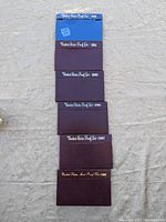 Six United States Proof Set folders stacked vertically from 1983 to 1988 showing colors and labels