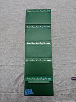 Five green envelope folders each labeled for US Mint Proof Sets from 1994 to 1998 in a vertical arrangement.