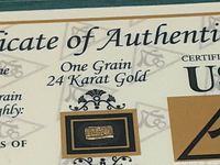 Close-up of the gold bar inside its certificate of authenticity, showing the bar marked with its weight and purity.