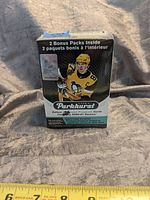 Box of 2020-21 Parkhurst hockey cards, front visible with player image and text indicating bonus packs inside.