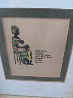 Framed African American art print showing a Black mother sitting holding children with accompanying poem and signature.