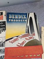 Cover of Bendix Products catalog showing stylized illustrations of vintage automobiles and brand name text in blue and yellow tones.