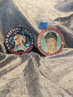 Two vintage circular Sportsflics baseball cards featuring Wade Boggs and Roger Clemens on a gray textured background with a measuring tape showing size.