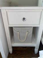 Front view showing drawer, knob and included basket.