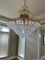 Full view of chandelier installed, showing chain, medallion and tiers of crystal spheres