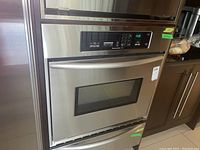 Front view of stainless steel convection oven with warming drawer below