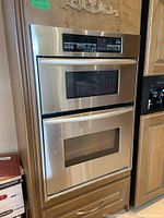Front view of the stainless steel microwave drawer above the oven door