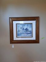 Framed limited edition print "Island Georgian Bay" by Franklin Carmichael hanging on wall, showing full frame and mat.