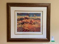 Full view of framed print hung on wall showing ornate wooden frame, matting, and artwork