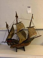 Full view of the square rigger model ship showing sails, masts, rigging, and hull details.