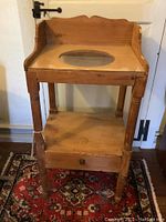 Front view of the wooden wash basin table showing oval cutout and drawer.