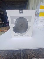 Box showing front view of earbuds and charging case graphic on white background