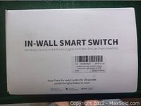Box packaging labeled 'IN-WALL SMART SWITCH' with details on wireless control and reset instructions.