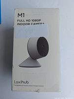 Front view of the Laxihub M1 Full HD 1080P indoor camera box showing product image and branding.