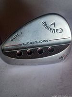Photo of the rear sole of the wedge showing Callaway branding, Mack Daddy 4 model, 58 degree loft, and C-Grind sole.