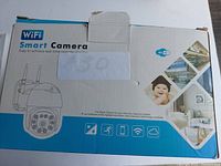Photo of the WiFi Smart Camera box showing key features and branding.