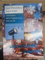 Image of snowflakes in motion projector box showing branding and product details.