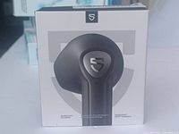 Front of retail box showing Shield brand wireless earbuds with branding and technical callouts including Qualcomm QCC3040 chip and open-fit design.