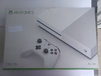 Front of original retail box showing Xbox One S console and controller illustration.