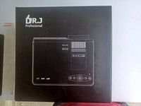 Black box packaging for Dr J Professional projector showing line drawing of projector on front panel.