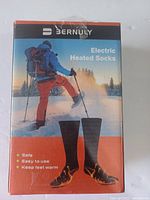 Front of the Bernuly Electric Heated Socks packaging showing product features such as safety, ease of use, and warmth.