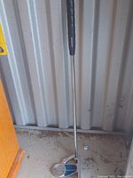 Photo of a G2P kids golf club showing the metal clubhead with a blue accent and black grip.