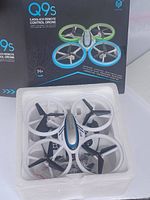 Photo of the Q9s drone in its original packaging with box and foam casing.