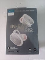 Front of the retail box showing Soundcore Liberty 2 Pro earbuds with branding and key features including Bluetooth, Qualcomm aptX, 32 hours playtime, and wireless charging.