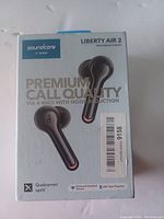 Front of the product box showing the earbuds and highlighting premium call quality with 4 mics and noise reduction. Qualcomm aptX logo visible.