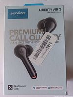 Front of the box showing product and key features like premium call quality, Qualcomm aptX technology, diamond-inspired drivers, and total 28-hour playtime.