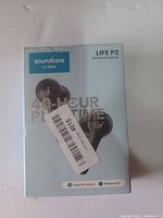 Front of Soundcore Life P2 earbuds retail box showing earbuds and packaging with branding and product name.