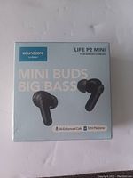 Front of box showing product name, brand, image of earbuds, and key features like AI-enhanced calls and 32H playtime