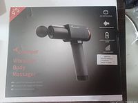 Front of original box showing the Sportneer vibration body massager and product name.