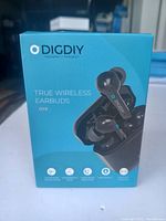 Front view of the DIGDIY D10 True Wireless Earbuds retail packaging box showing the earbuds inside the open charging case against a blue background with branding and product name.