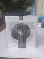 Front of retail box of Satozza TrueAir2 wireless earbuds showing a single earbud and brand logo, sealed in plastic.