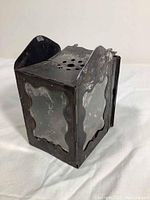 Black painted tin lantern with 4 original mica windowpanes shown on 3 sides, angled view