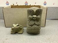 Both frog and owl cement garden decor pieces, with box background