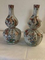 Front view of both vases showing shape and matching decoration