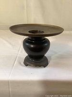 Front side view of bronze Ikebana vase showing wide flat dish mounted on rounded base