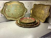 Overall view of the set of six hand painted wood trays showing colors and varying shapes