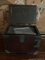 Closed hinged wooden box with metal corner and latch details