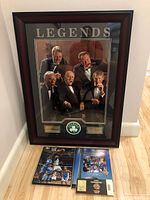 Framed Celtics Legends photo with four supporting Basketball Hall of Fame memorabilia items below it on the floor.