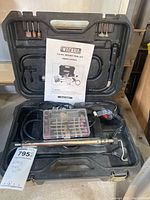 Full kit in black plastic case with instructions, rotary tool, accessories, flexible shaft attachment inside.