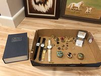 Overview of all items including dictionary, watches, pins, trinket boxes and lockbox.