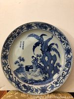 Front view of the Imari style charger plate showing the scenic painted image and floral border.