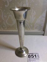 Full view of the sterling silver bud vase showing its trumpet shape and polished surface.